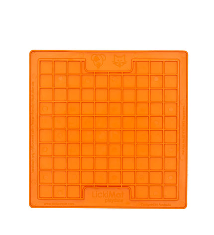 Orange TPR dog lick mat from Lickimat with textured surface, designed for feeding and calming dogs.