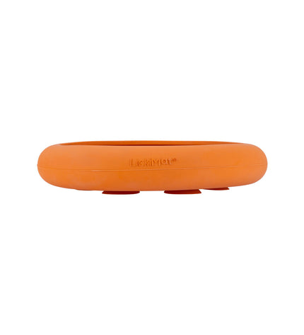 Orange rubber Lickimat dog feeder with textured surface, designed for dogs to lick and enjoy.