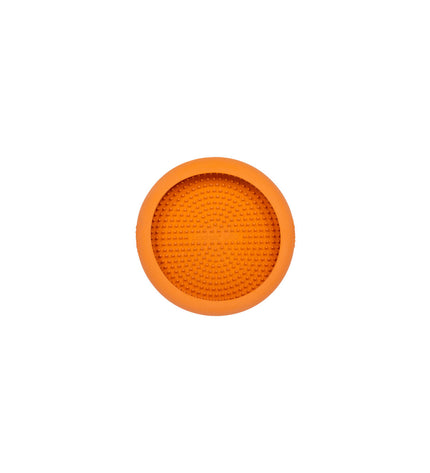 Orange rubber Lickimat dog feeding bowl with textured surface for dogs, designed for licking and enrichment.