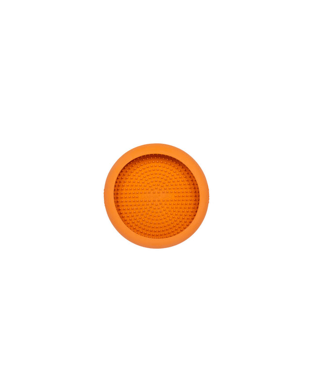 Orange rubber Lickimat dog feeding bowl with textured surface for dogs, designed for licking and enrichment.