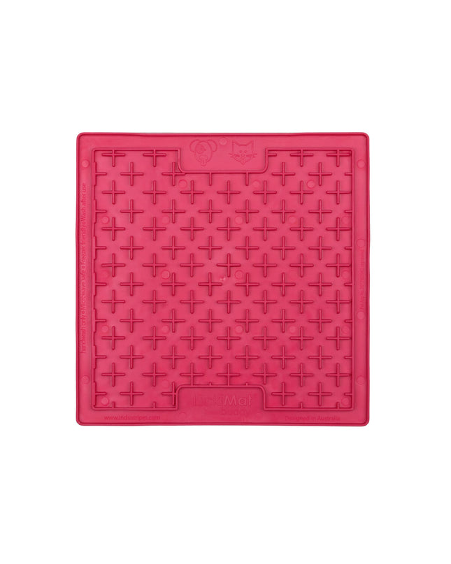 Pink TPR dog lick mat with raised surface for dogs, designed by Lickimat, used for feeding and soothing pets.