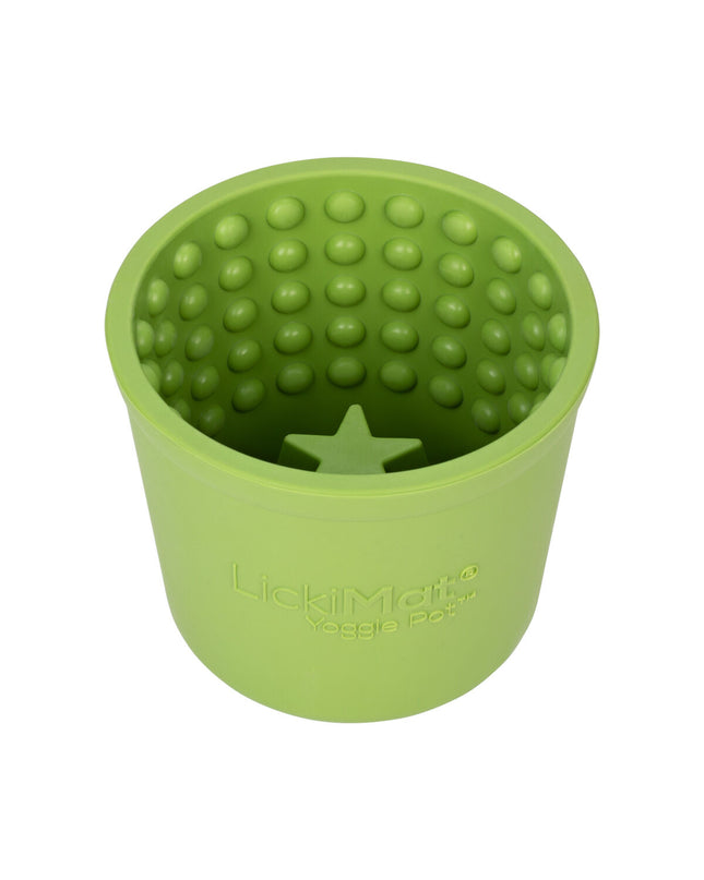 Green rubber dog lick mat from Lickimat, designed for feeding and soothing dogs, with textured surface for licking and chewing.
