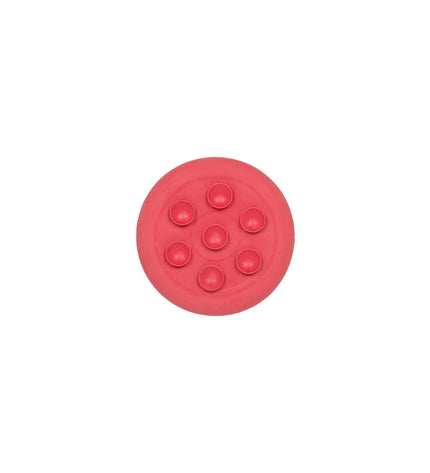 Pink rubber dog lickimat in a dog product image, designed to soothe and entertain pets with tasty treats.