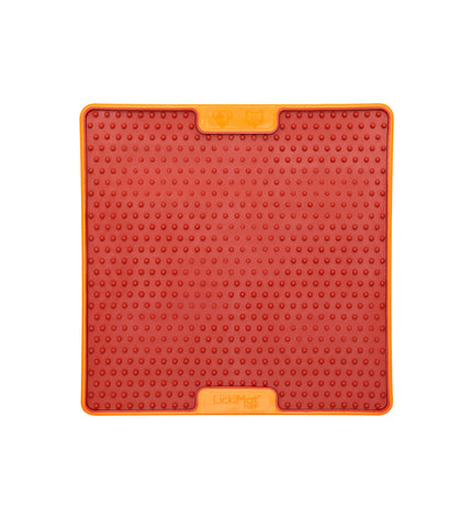 Orange Lickimat dog feeding bowl made of polypropylene and TPR, designed for dogs to lick and enjoy.