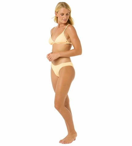 Rip Curl La Joya Tri Bikini in yellow, suitable for sport and watersports, displayed on a model with ocean background