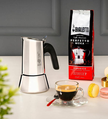 Bialetti New Venus Italian coffee pot in silver metal, stainless steel, used for making espresso in kitchen and household.