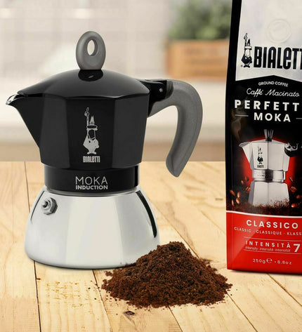 Black Bialetti Italian coffee pot made of aluminum, used for brewing traditional espresso on the stove.