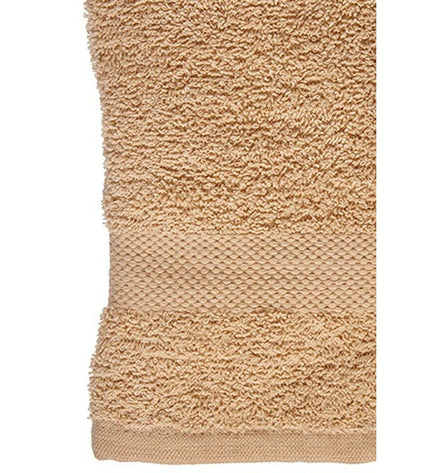 Set of six Berilo Crème bath towels, 80% cotton and 20% polyester, 50x90 cm, shown folded on a bathroom shelf.