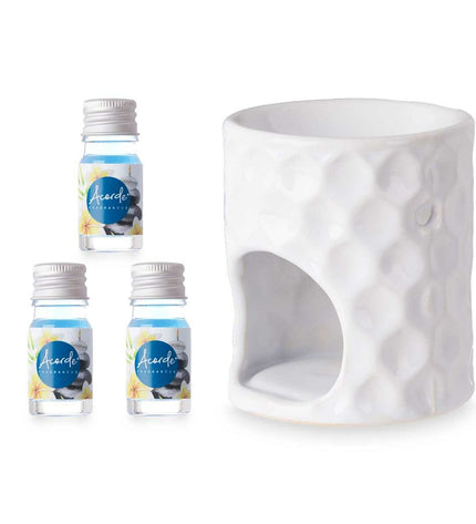 Acorde essential oil burner for home decor, shown with 12 bottles of essential oils on a kitchen countertop.
