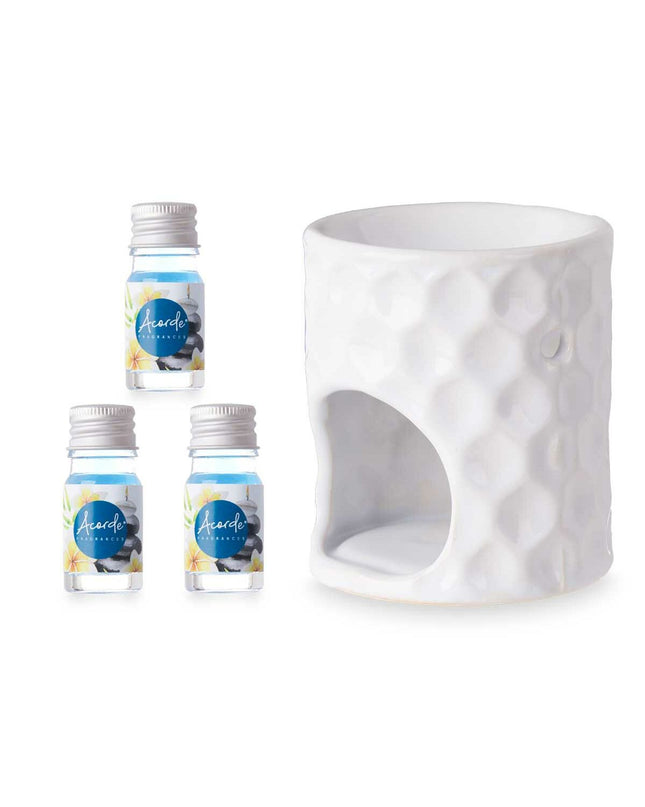 Acorde essential oil burner for home decor, shown with 12 bottles of essential oils on a kitchen countertop.