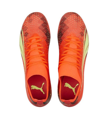 Orange Puma Ultra Match MG adult football shoes for outdoor soccer, featuring sporty design and lightweight construction.