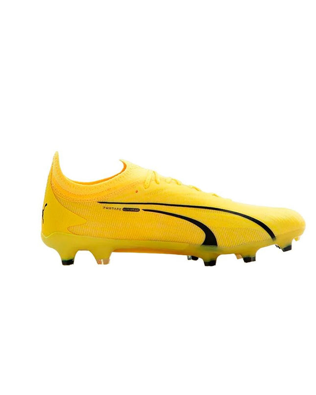 Adult Puma soccer cleats for outdoor football, featuring black and white design with textured surface and studded sole.