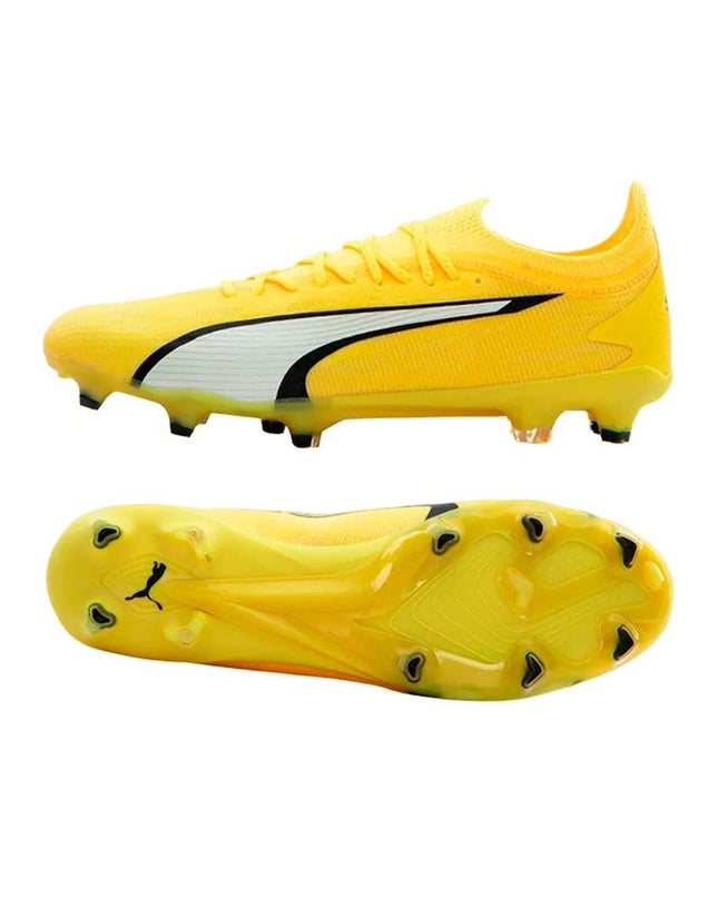 Adult Puma soccer cleats for outdoor football, featuring black and white design with textured sole and branding details.