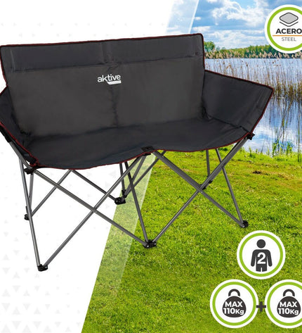 Two black Aktive foldable 2-seater benches for outdoor camping and sports, measuring 107 x 88 x 63 cm, shown in a natural setting.