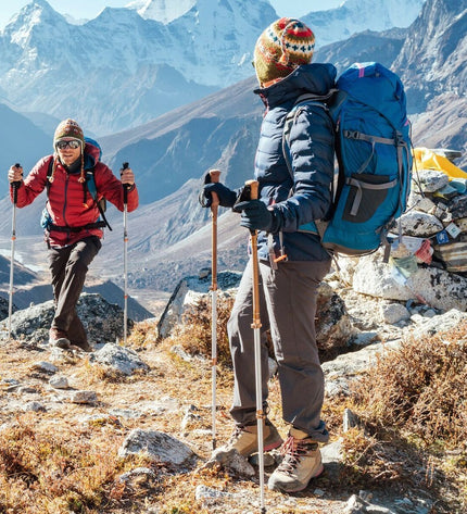 Pair of Aktive Aluminium Trekking Poles, 135 cm, designed for outdoor hiking and camping, shown in a natural outdoor setting.