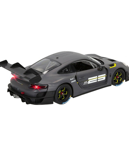 Two Porsche remote-controlled toy cars on a smooth surface, detailed red and black miniature vehicles for play and collection.
