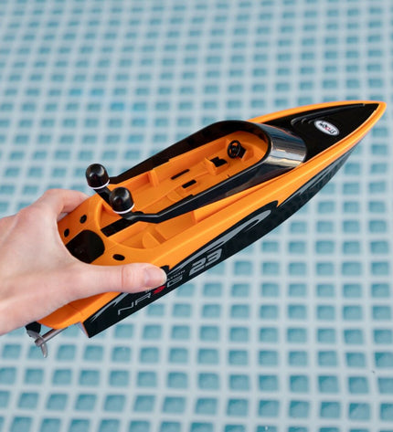 Two Colorbaby remote-controlled toy boats in vibrant colors, designed for play and fun on water.