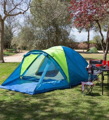 Pair of Aktive camping tents in green with mesh windows, set up outdoors on grass, ideal for outdoor camping and hiking adventures.