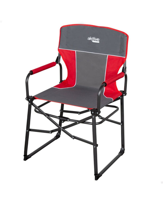 Two Aktive foldable camping chairs in black with armrests, set up outdoors on a grassy area.