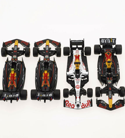 Four Red Bull Verstap toy cars in red and black, small plastic vehicles for children, displayed together on a white background.