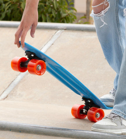 Set of four EVO skateboards for kids, colorful plastic decks with wheels, suitable for outdoor play and sports activities.