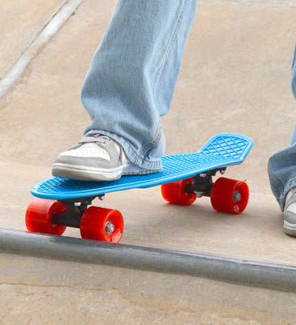 Set of four EVO skateboards for kids, featuring colorful decks suitable for outdoor and sports play.