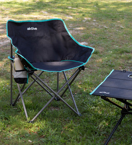 Pair of Aktive foldable outdoor camping chairs in black with metal frames, compact for hiking and outdoor activities.