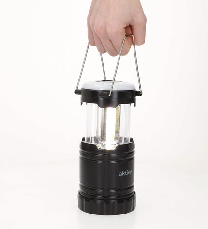 Six Aktive plastic camping outdoor garden lights arranged outdoors, ideal for decorating garden or camping area.
