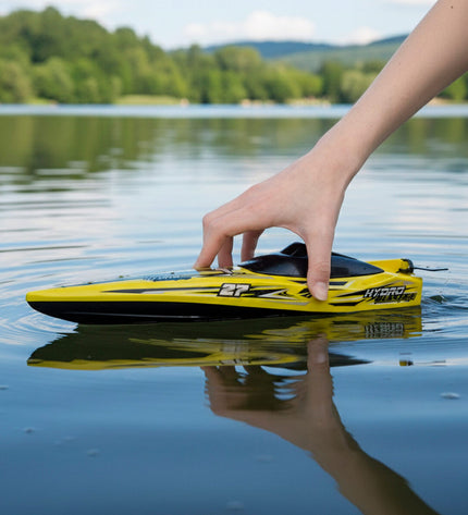 Six Maisto radiographically controlled toy boats displayed outdoors, showcasing detailed miniature vehicle models in a playful setting.