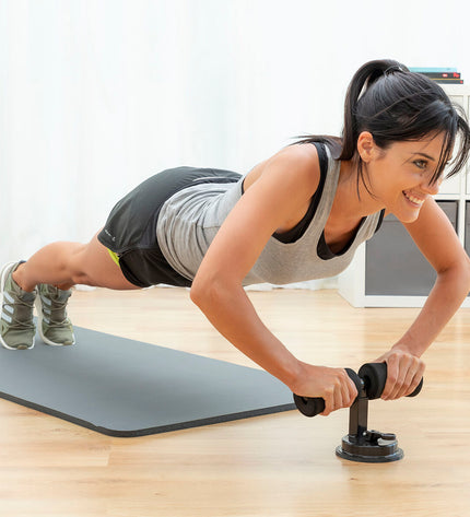 InnovaGoods CoreUp abdominal grip with suction cup and exercise guide for fitness workouts on a flat surface.