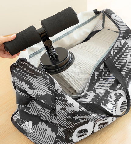InnovaGoods core workout grip with suction cup and exercise guide for abdominal fitness, shown on a workout surface.