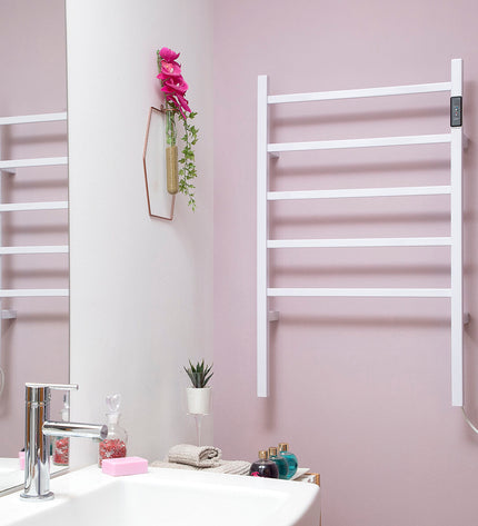 InnovaGoods electric wall or floor towel rail in black, mounted in a modern bathroom with towels hanging on it.