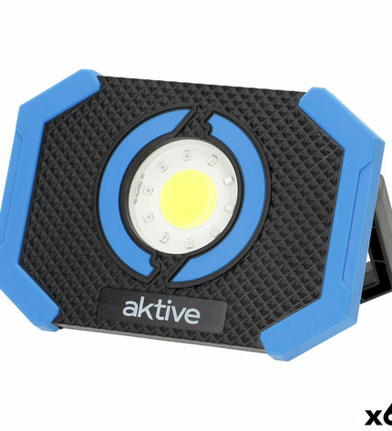 Set of six Aktive LED spotlight outdoor garden decor lights illuminating a garden area at night.